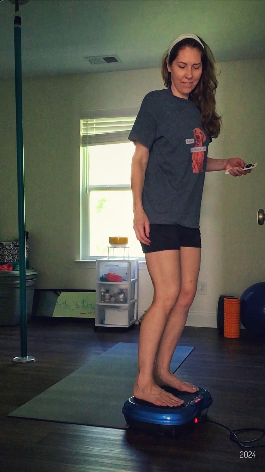 Woman standing on a vibration plate for PTSD relief and self-care